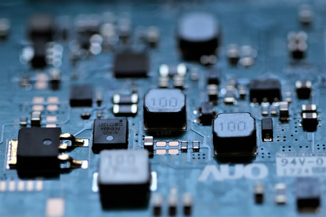 Macro photograph of a green motherboard with shallow depth of field.